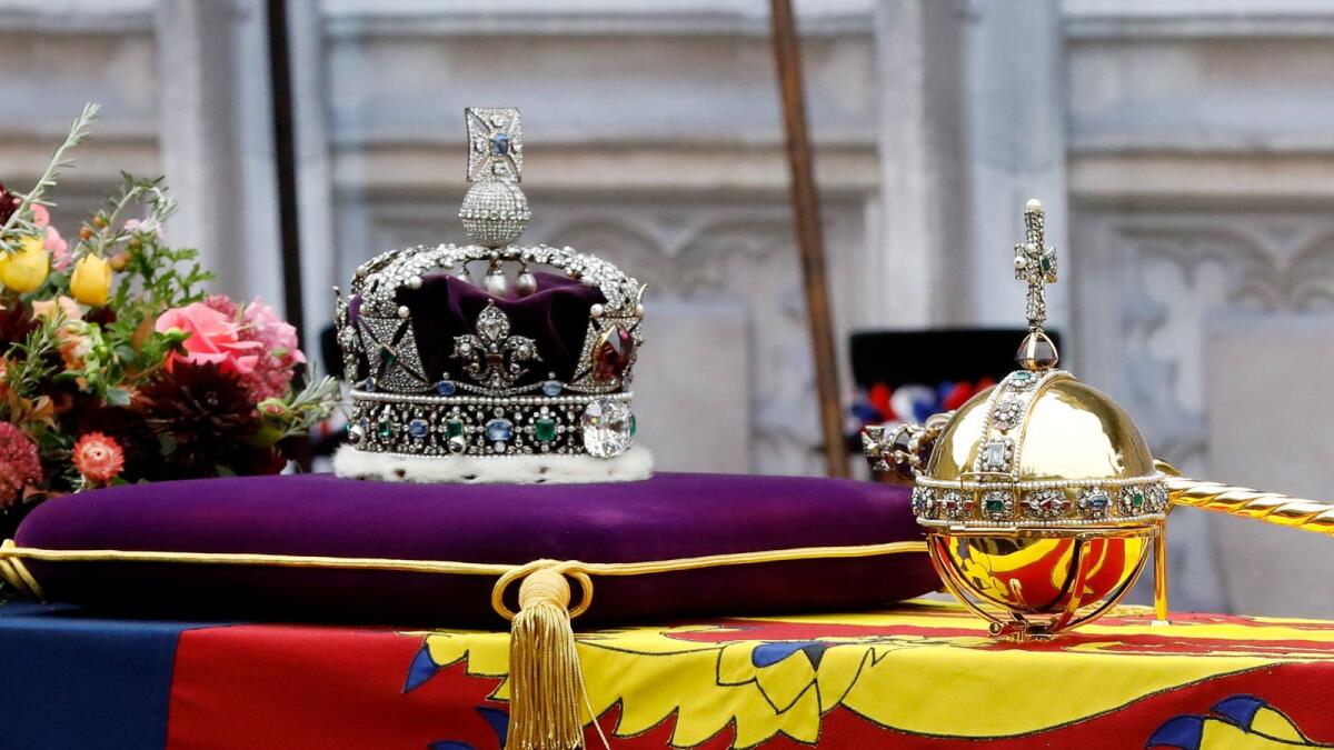 The coffin of Queen Elizabeth II with the Imperial State Crown resting on top is carried into Westminster Abbey.