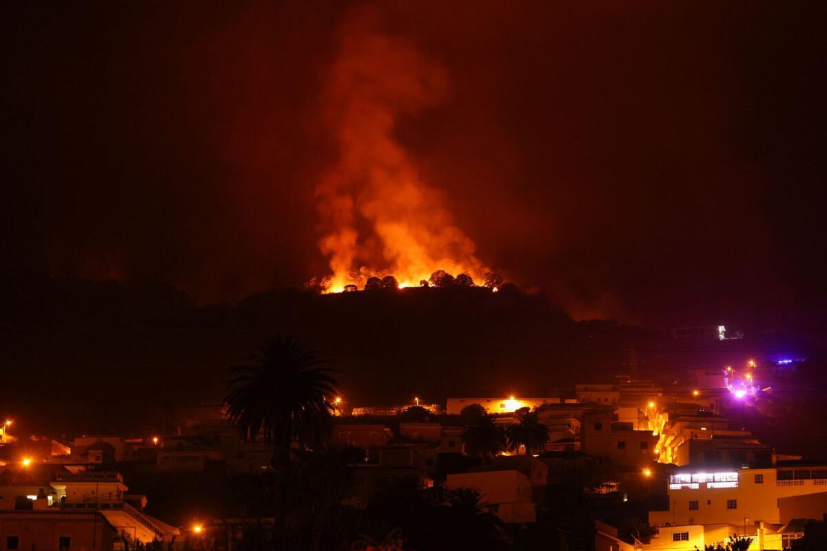 A view shows a fire over the mountains near empty houses after the evacuation in different villages in the north, as wildfires rage out of control on the island of Tenerife, Canary Islands, on Sunday. — Reuters