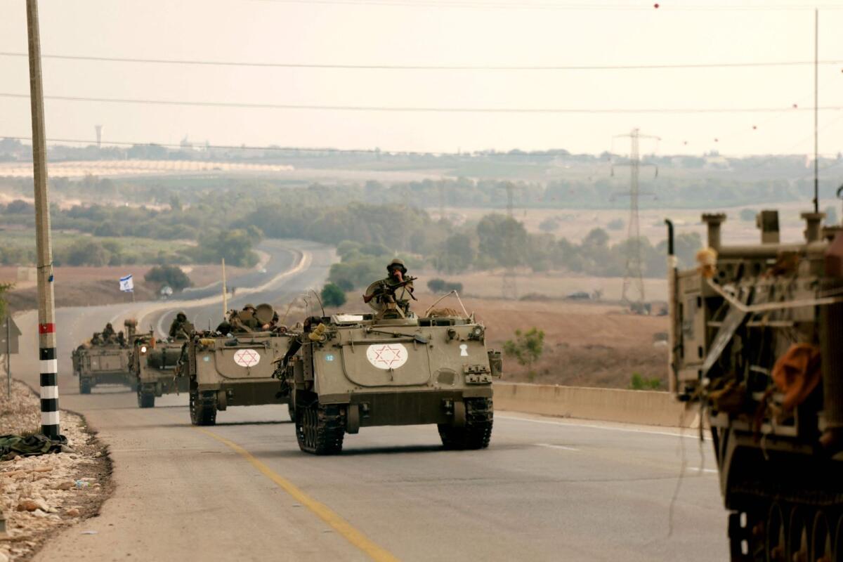 Israeli soliders ride in their armoured vehicles towards the border with the Gaza Strip on October 16, 2023. Photo: AFP