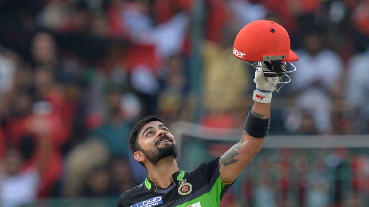 Royal Challengers of Bangalore captain and batsman Virat Kohli gestures after scoring 100 runs during the 2016 Indian Premier League (IPL) Twenty20 cricket match between Royal Challengers Bangalore and Gujarat Lions, at The M. Chinnaswamy Stadium in Bangalore on May 14, 2016./ GETTYOUT /  ----IMAGE RESTRICTED TO EDITORIAL USE - STRICTLY NO COMMERCIAL USE----- / GETTYOUT / / AFP / MANJUNATH KIRAN
