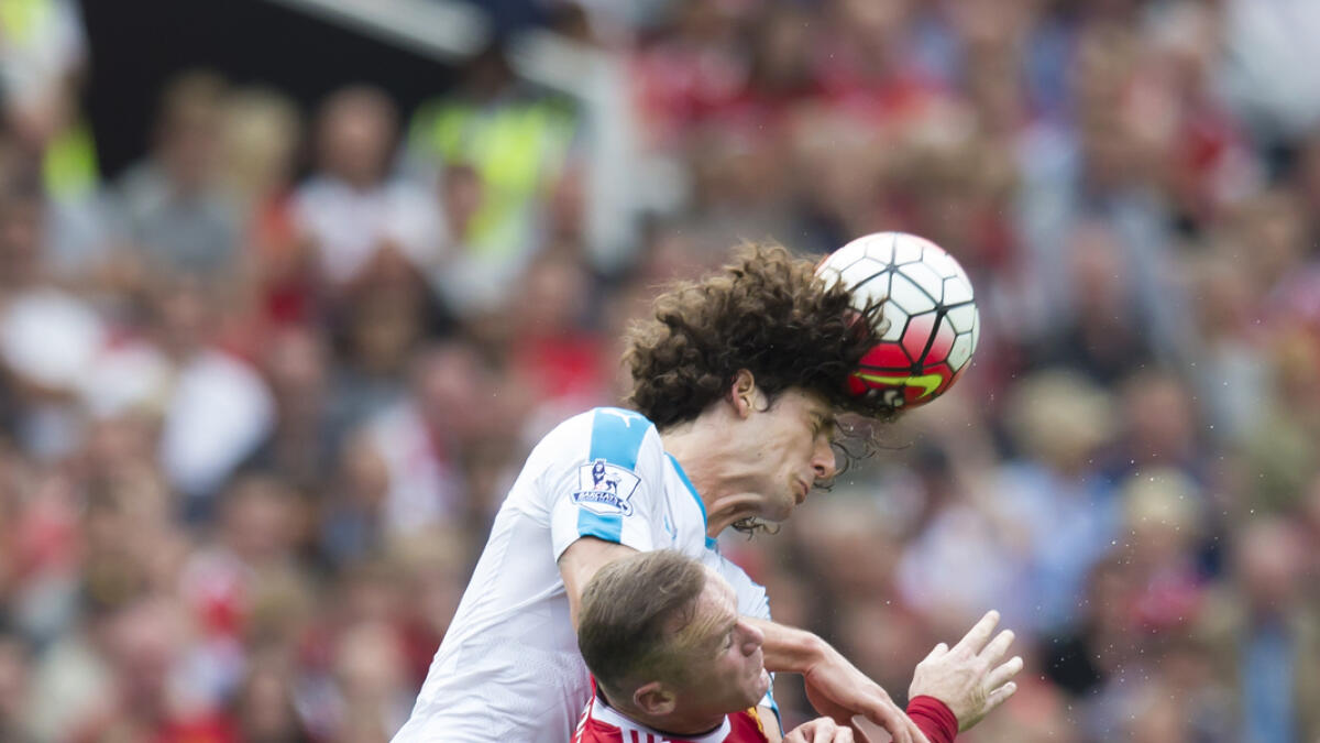 Manchester Uniteds Wayne Rooney, bottom fights for the ball against Newcastles Fabrizio Coloccini. 