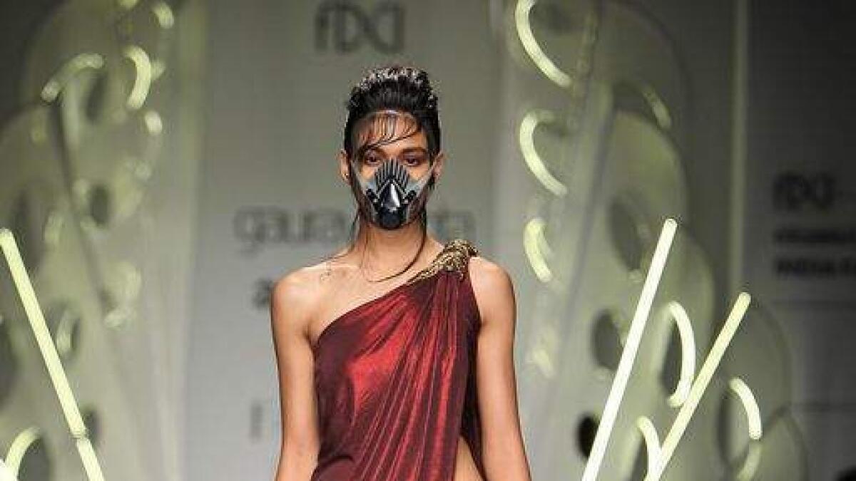 With breathing masks on, fashion brigade catwalks against pollution