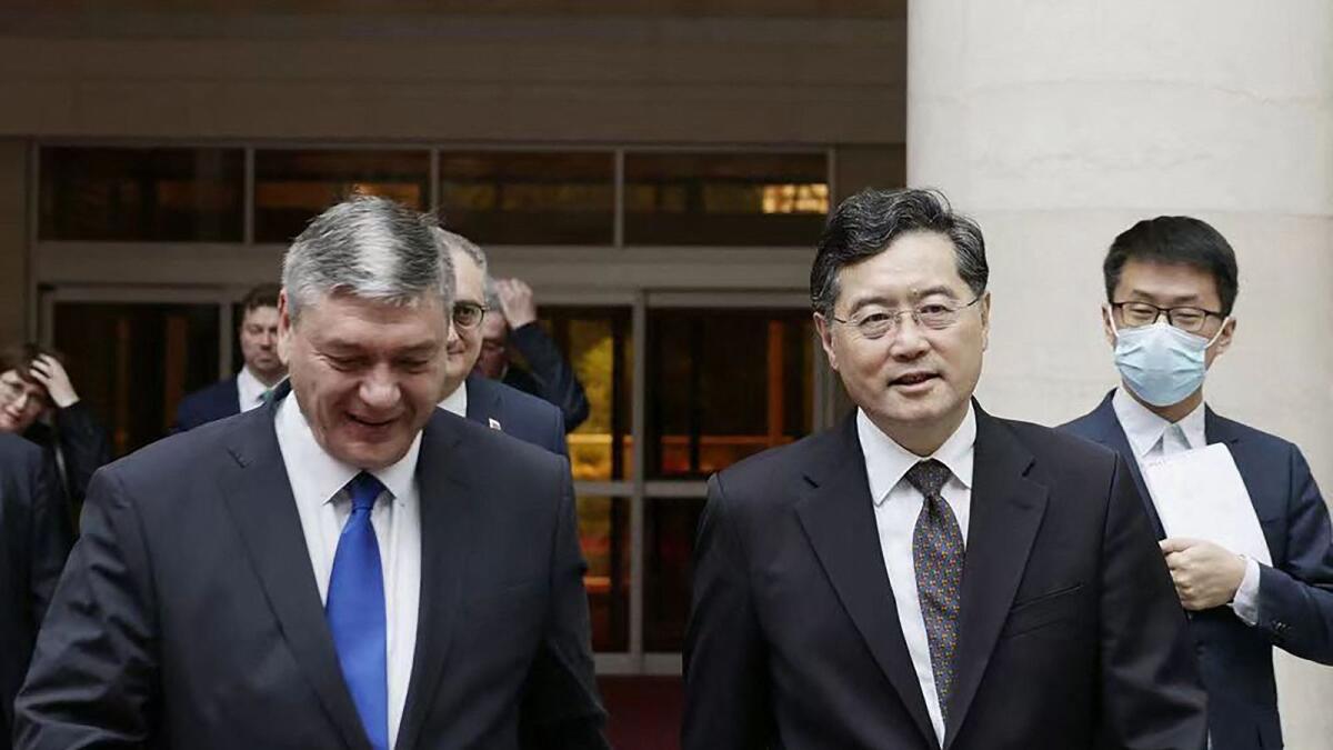 Russia's deputy foreign minister Andrey Rudenko and China's Foreign Minister Qin Gang  walk together as they meet in Beijing. — AFP