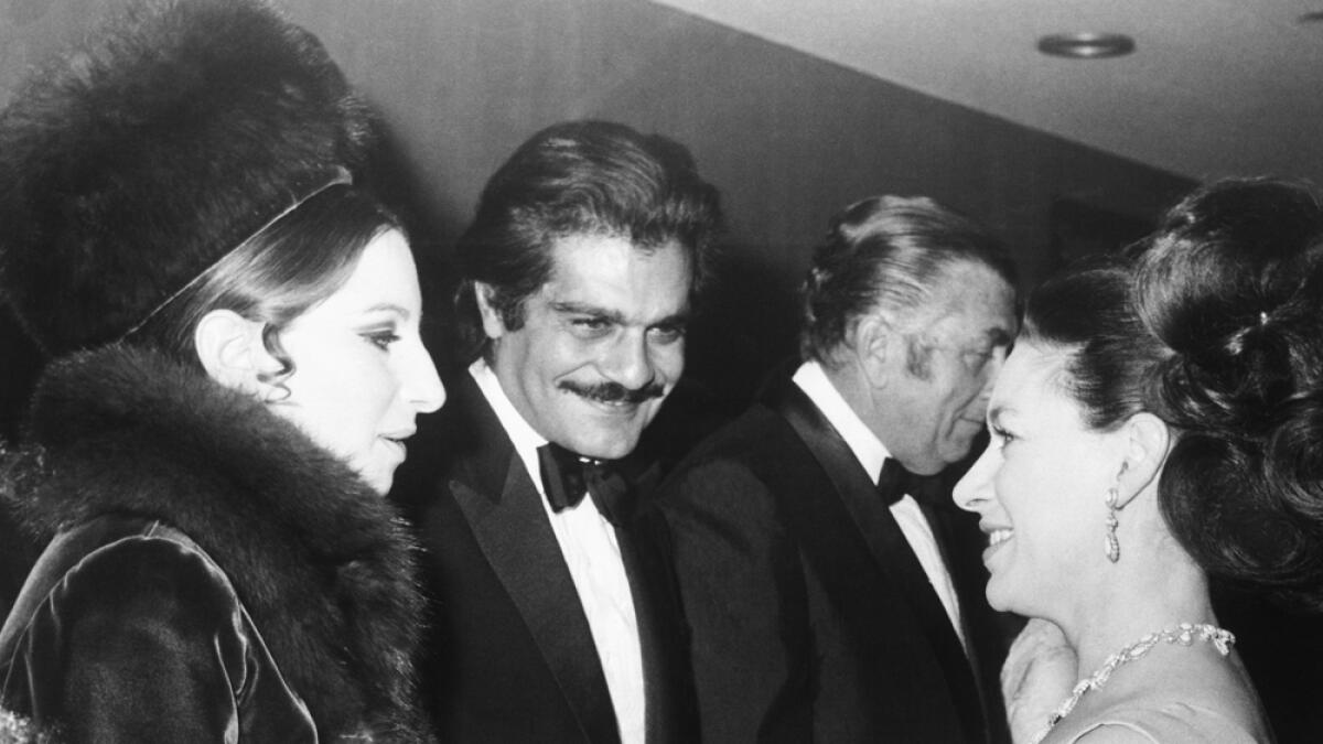 In this Jan. 15, 1969 file photo, Britain's Princess Margaret, right, talks with American singer Barbra Streisand, left, and actor Omar Sharif, center, at the premiere of the film 'Funny Girl,' at the Odeon Cinema, London.