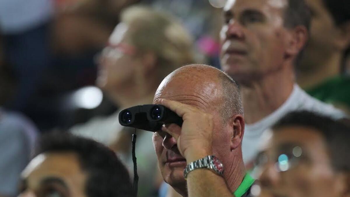 LET ME GET A CLOSER VIEW. A spectator uses binocular to watch match between Stan Wawrinka (SUI) and Sergiy Stakhovsky (UKR) in the  Dubai Duty Free Tennis Championships on Tuesday, 23 February 2016. Photo by Kiran Prasad