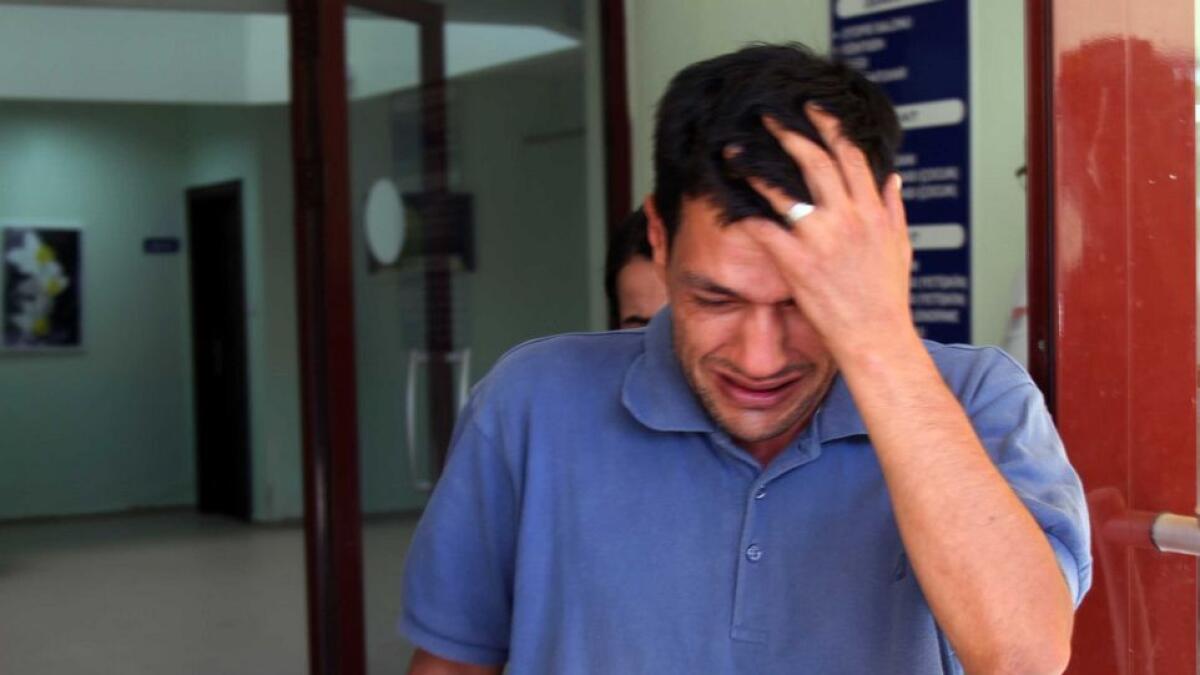 Abdullah Kurdi, 40, father of Syrian boys Aylan, 3, and Galip, 5, who were washed up drowned on a beach near Turkish resort of Bodrum on Wednesday, cries as he waits for the delivery of their bodies outside a morgue in Mugla, Turkey.
