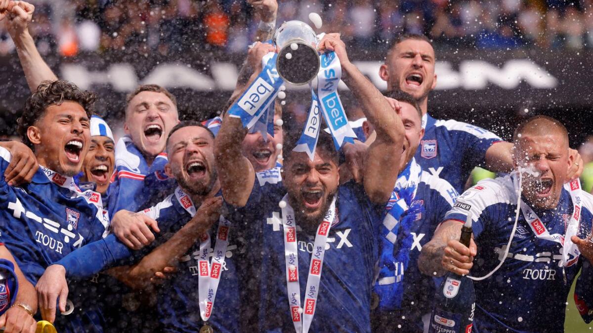 Ipswich Town players celebrate with a trophy following their promotion to the Premier League. - Reuters