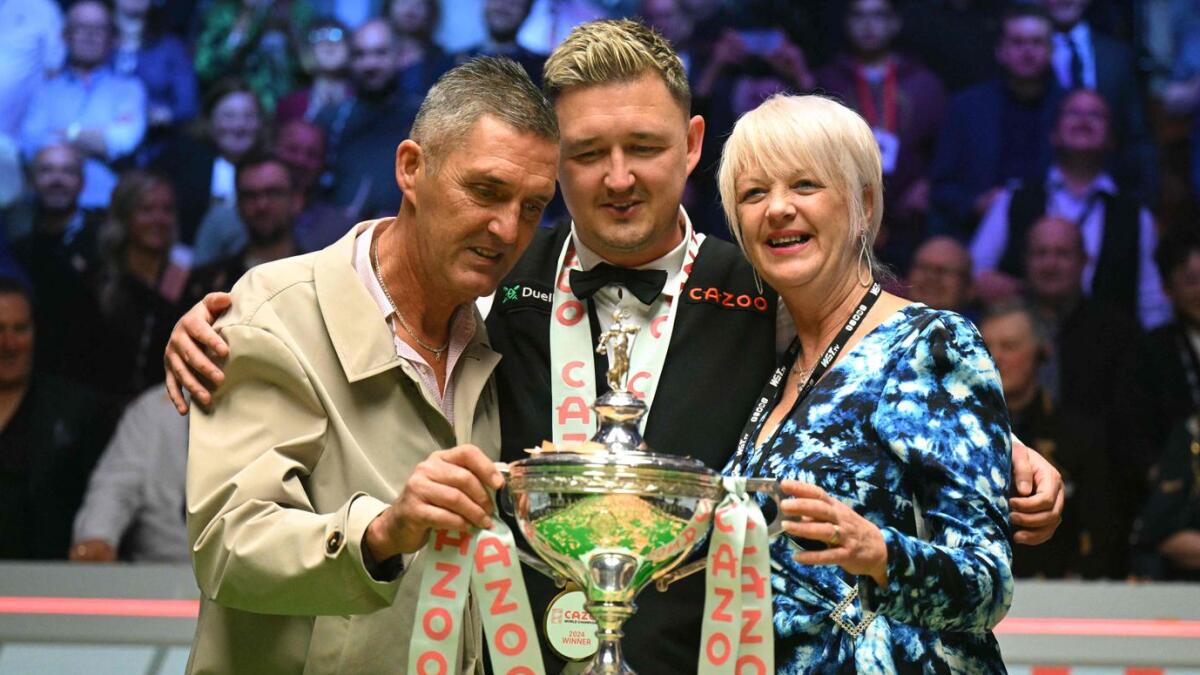 England's Kyren Wilson poses with the trophy and mother Sonya and father Rob, after winning the World Championship Snooker final at The Crucible in Sheffield. Wilson beat Zak Jones 18-14.