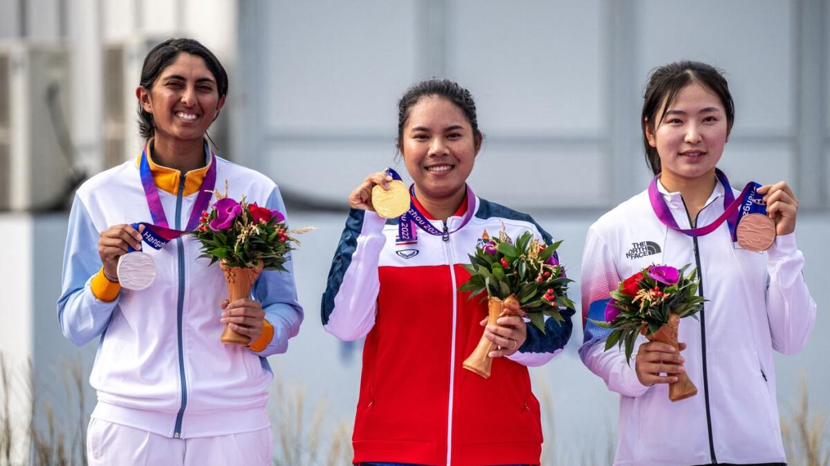 (L to R) Silver medallist India's Aditi Ashok, gold medallist Thailand's Arpichaya Yubol and bronze medallist South Korea's Yoo Hyunjo attend the medal ceremony for the women's individual golf event at the Hangzhou. - AFP