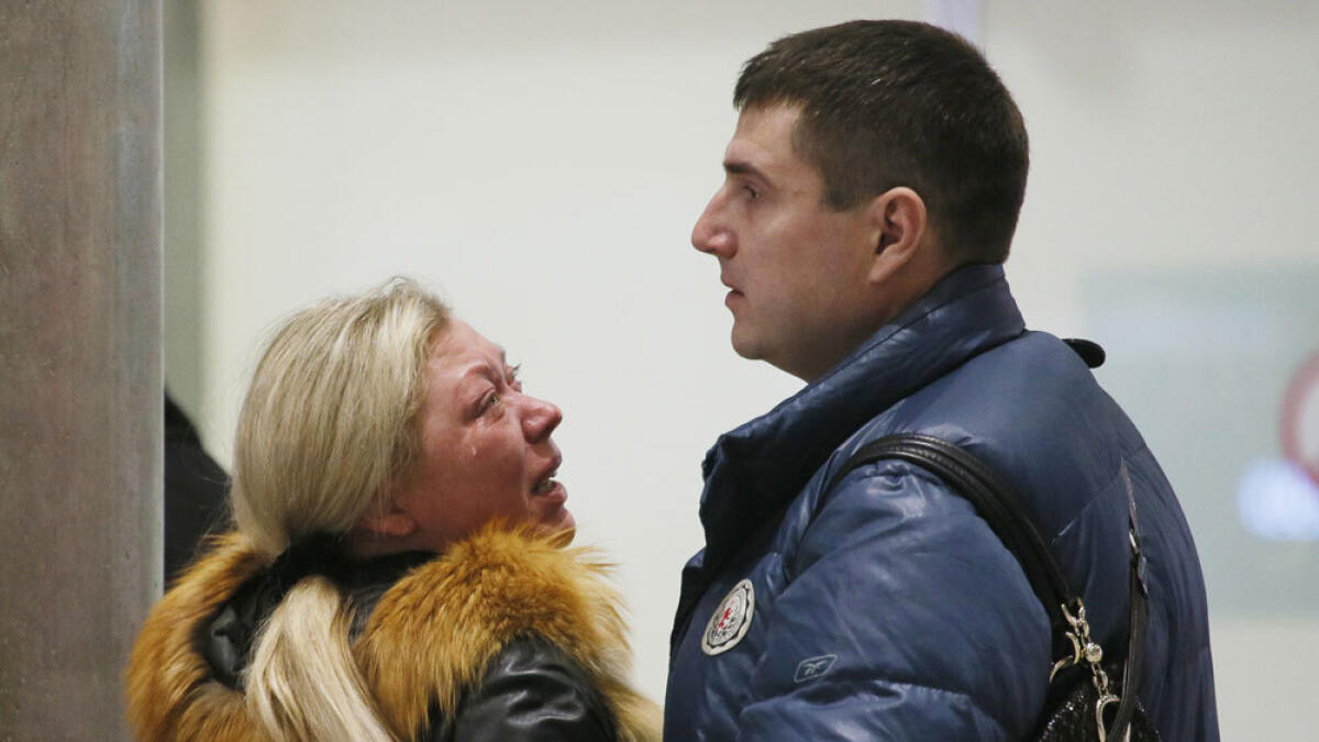Relatives react after a Russian airliner with 217 passengers and seven crew aboard crashed, as people gather at Russian airline Kogalymavia’s information desk at Pulkovo airport in St.Petersburg.