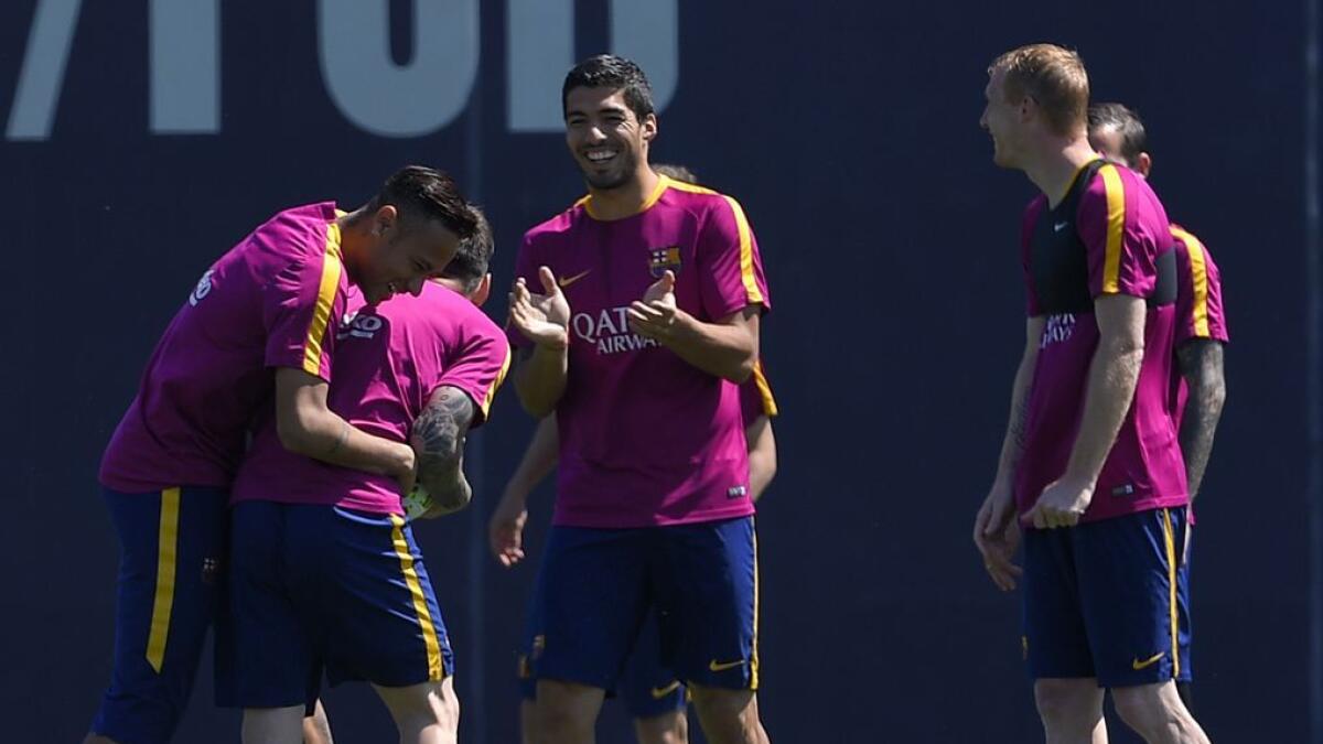 Barcelona’s Neymar (left), Lionel Messi, Luis Suarez and Jeremy Mathieu share a light moment during a training session on the eve of the final of the Copa del Rey against Sevilla FC.