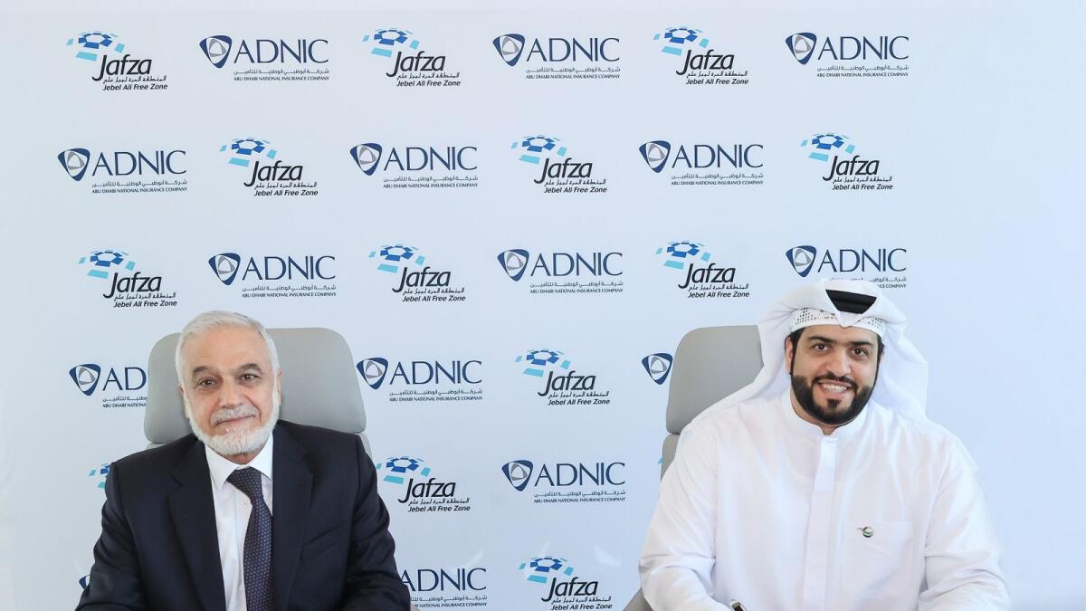 Ahmad Idris, chief executive officer of Abu Dhabi National Insurance Company, and Ahmad Al Haddad, chief operating officer, Parks and Zones, DP World UAE, signing the agreement. — Supplied photo 