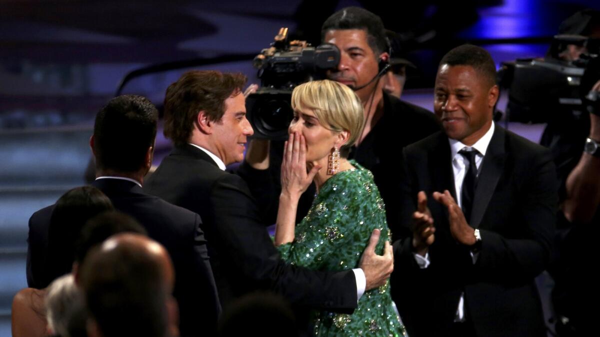 Sarah Paulson is congratulaed by John Travolta (L) and Cuba Gooding Jr. (R) as she wins the award for Outstanding Lead Actress In A Limited Series Or Movie for 'The People v. O.J. Simpson: American Crime Story' at the 68th Primetime Emmy Awards in Los Angeles, California, US, September 18, 2016. Reuters