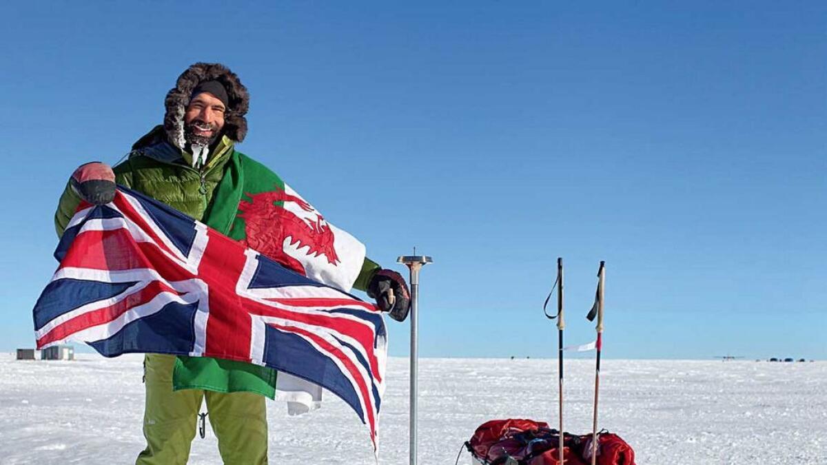 Richard Parks at the geographical South Pole marker during the Antarctica expedition. 