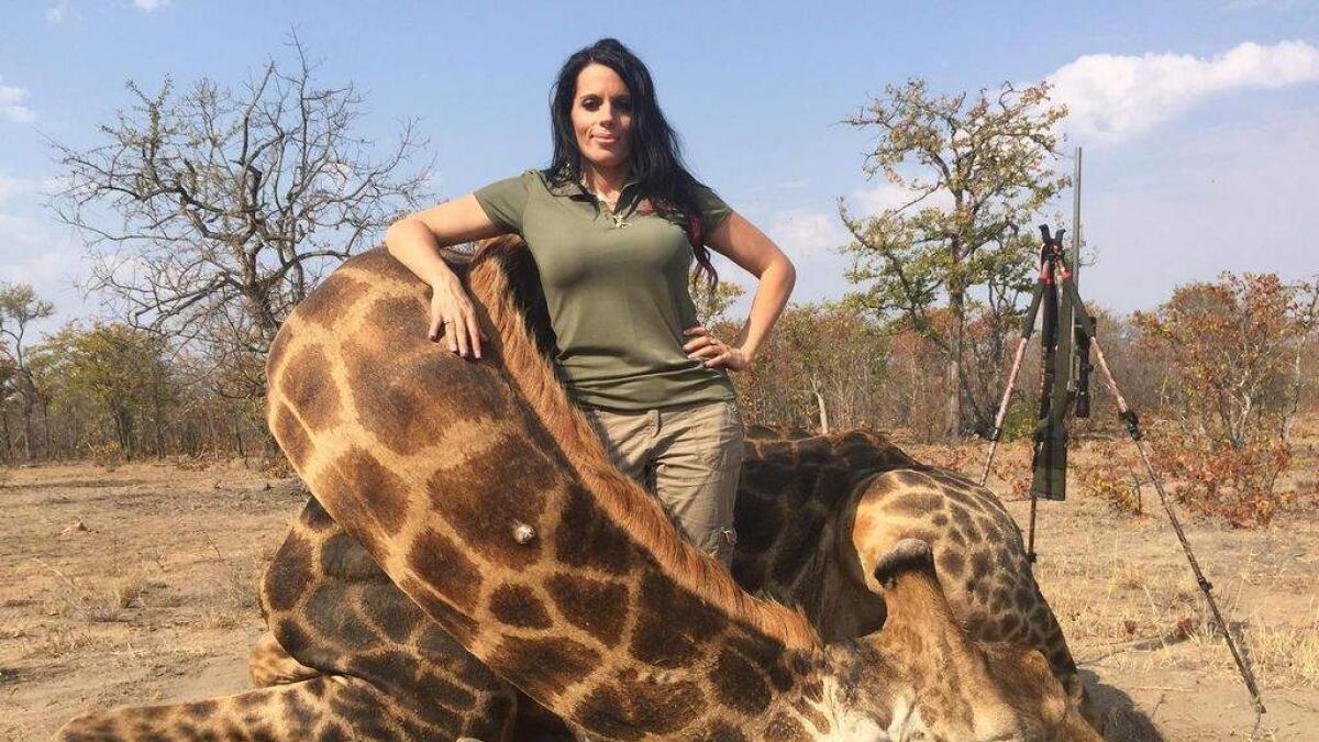 Sabrina Corgatelli poses with a dead giraffe