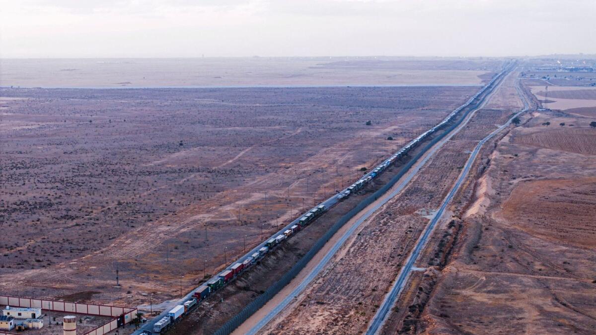 A drone picture of a line of trucks waiting on an Egyptian road along the border with Israel, near the Rafah border crossing with the Gaza Strip. — Photo: Reuters