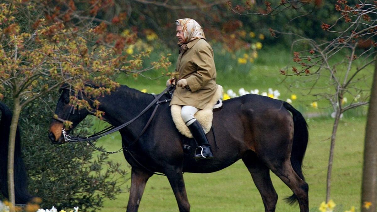 Queen Elizabeth II rides her horse on the grounds of Windsor Castle. — Reuters file