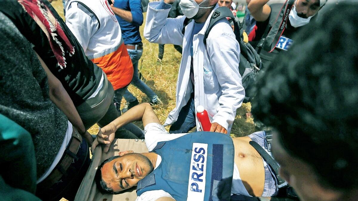 Mortally wounded Palestinian journalist Yasser Murtaja, 30, is evacuated during clashes with Israeli troops at the Israel-Gaza border, in the southern Gaza Strip.—Reuters