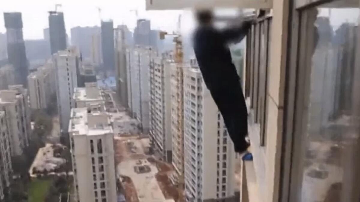 Man attempts to escape arrest by climbing out of 23rd floor window
