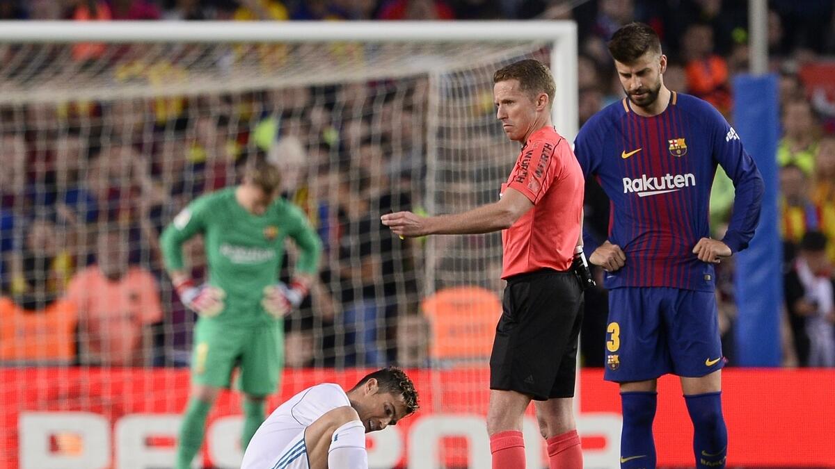 Messi strike helps 10-man Barca earn draw as Ronaldo goes off injured