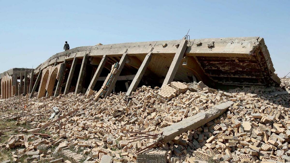 The damaged tomb of Saddam Hussein in the village of Al Awja, on the outskirts of Tikrit. — AFP