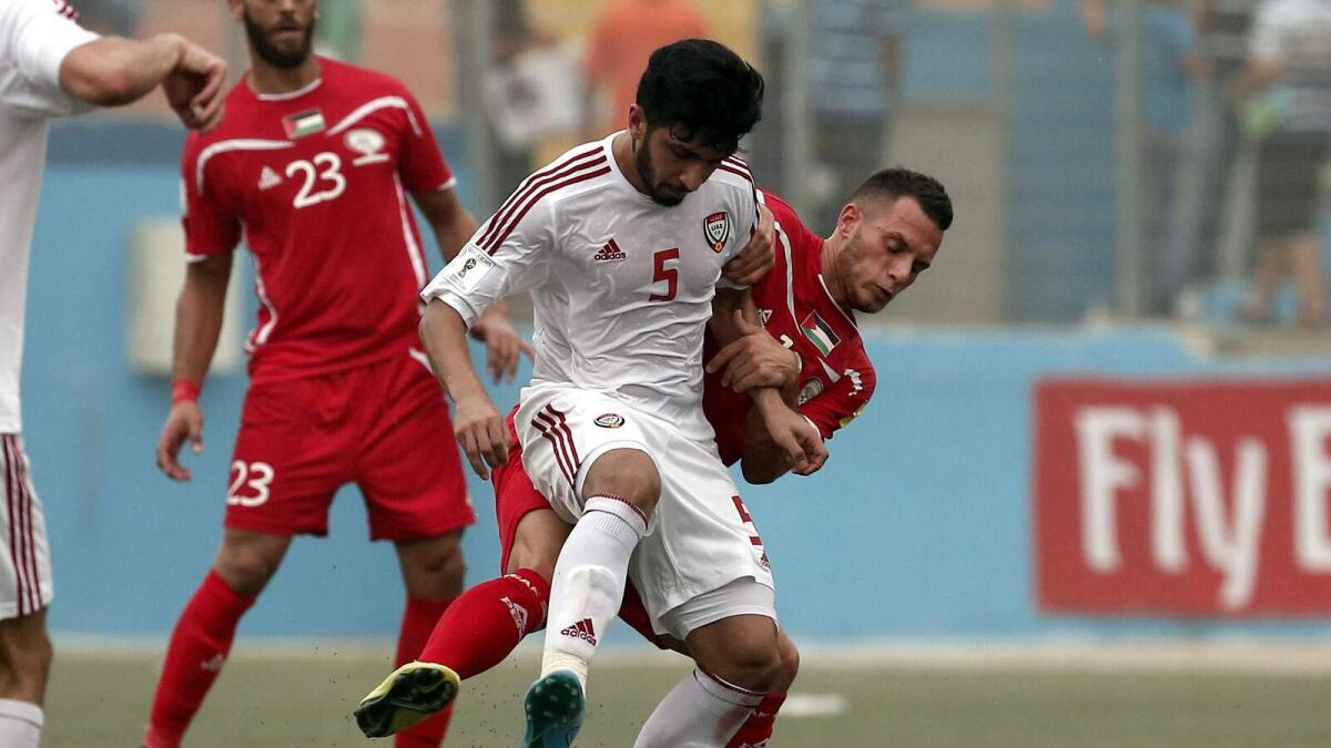 Palestine’s Jaka Hbaisha (red) vies for the ball with UAE’s Amer Abdulrahman. 