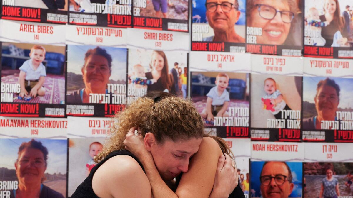 Dr Adva Gutman-Tirosh and Lee Dan, whose family members were abducted, comfort each other as the families of people who are missing or were abducted from Israel, following a deadly infiltration by Hamas gunmen from the Gaza Strip, hold a press conference. — Reuters