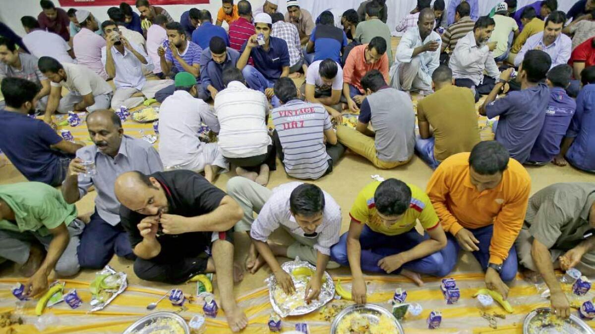 People end their fast with Iftar meals provided at the Emirates Red Crescent Ramadan tent in Abu Dhabi. — Photo by Ryan Lim