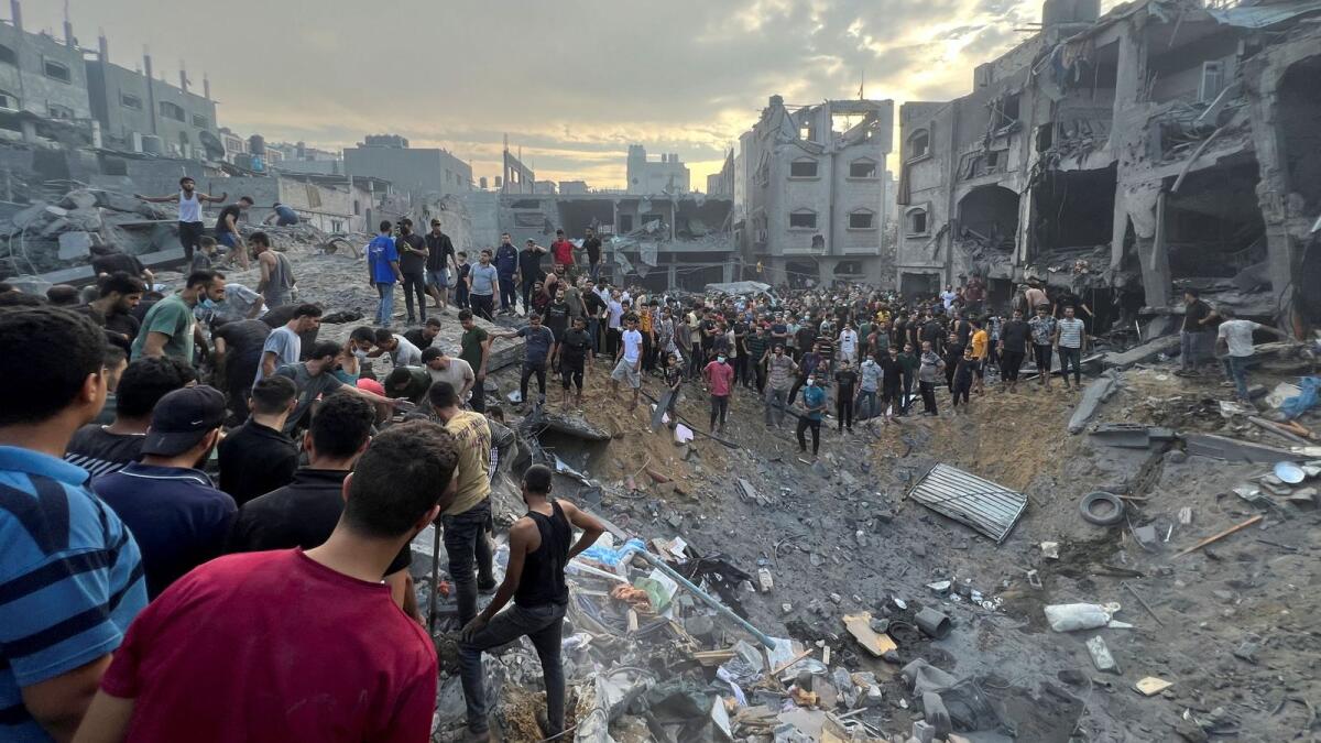 Palestinians search for casualties at the site of Israeli strikes on houses in Jabalia refugee camp in the northern Gaza Strip on October 31. — Reuters