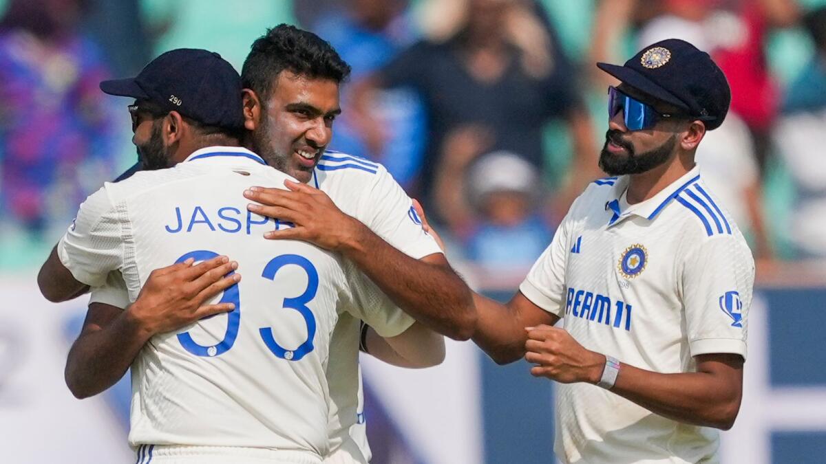 Rajkot: India's Ravichandran Ashwin celebrates reaching the miwith teammates after taking the wicket of England's Zak Crawley on the second day of the third Test  between India and England. - PTI