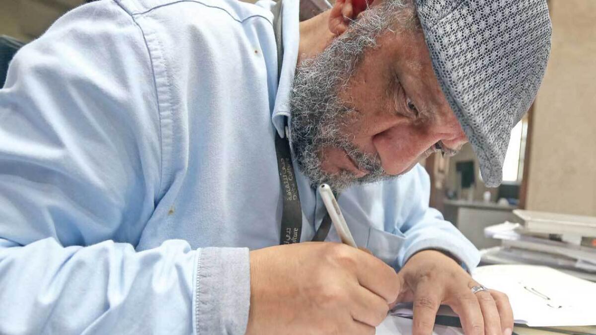 Egyptian expat and teacher Abdul Fattah Mohammed Malha has been practising Caligraphy since 1980. — Photo by Dhes Handumon