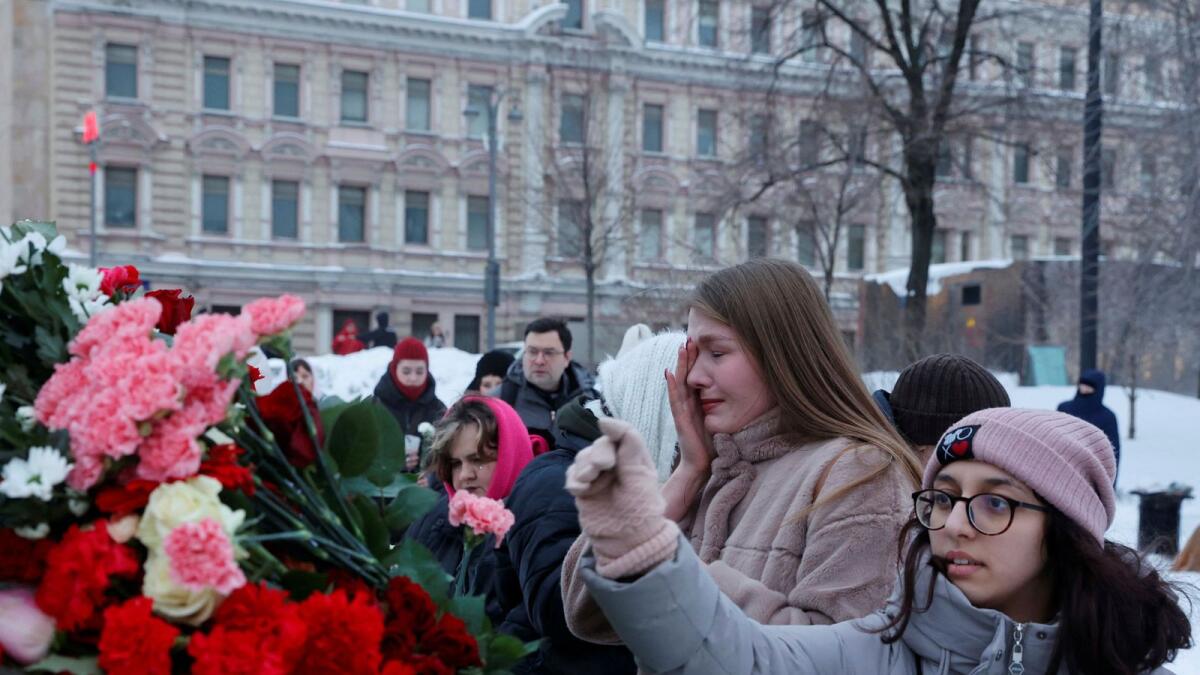 People lay flowers at the Solovetsky Stone monument to the victims of political repressions to honour the memory of Russian opposition leader Alexei Navalny in Moscow. — Reuters