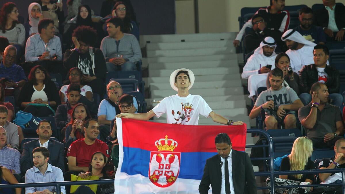 A spectator with a flag during the Novak Djokovic and Tommy Robredo match in the Dubai Duty Free Tennis Championships at Dubai Tennis Stadium on Monday, 22 February 2016. Photo by Kiran Prasad