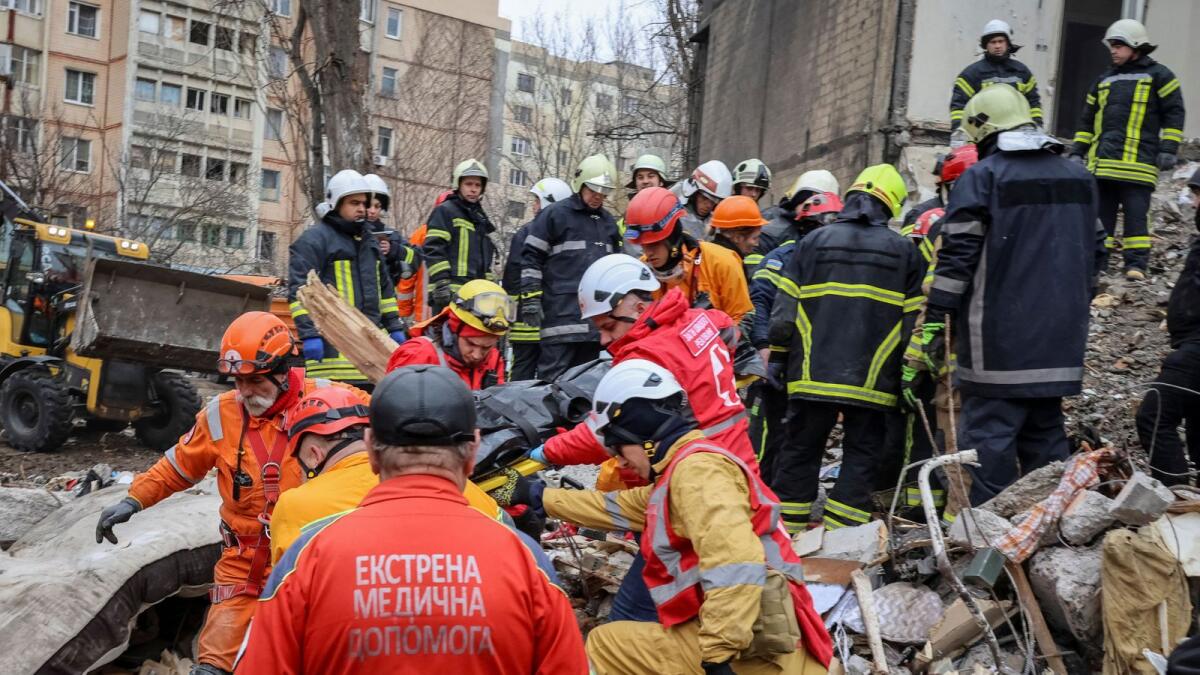 Rescuers remove the body of a local resident at the site of a residential building heavily damaged by a Russian drone strike in Odesa. — Reuters