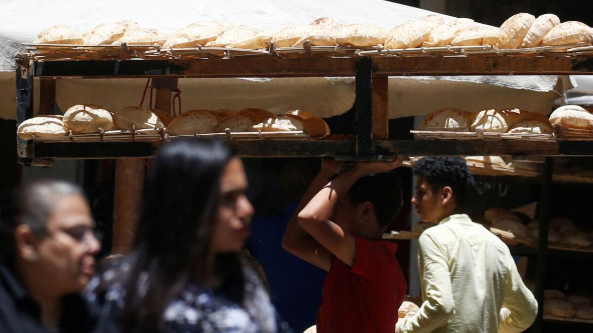 An Egyptian man carries bread on wooden racks to be sold to customers in the capital Cairo, Egypt June 3, 2024. Egypt's government has recently signalled its intention to move fully away from subsidising goods to a cash subsidy system.— Reuters