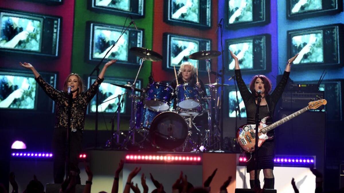 Belinda Carlisle, from left, Gina Schock and Abby Travis, of the The Go Go’s, perform ‘We Got The Beat’ at the Billboard Music Awards.