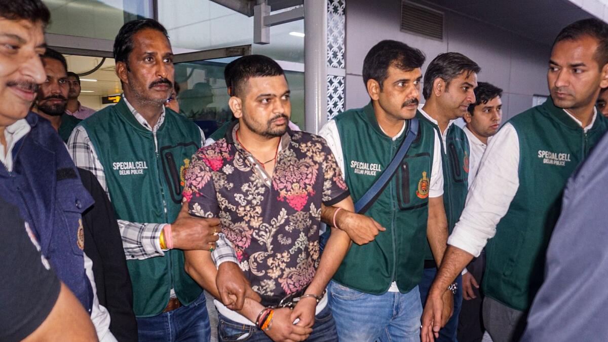 Gangster Deepak Boxer, a wanted fugitive in India, being brought from Mexico by Delhi Police's special cell team following his arrest in New Delhi on Wednesday. — PTI