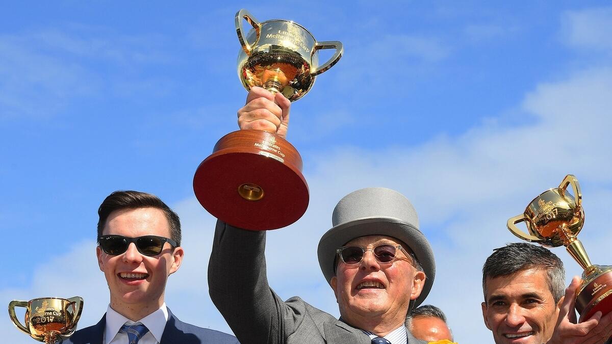 Lloyd Williams, owner of Rekindling, holds aloft the trophy as he stands with Jockey Corey Brown and Joseph O'Brien after winning the 157th version of the A$6.2 million ($4.77 million) MelbourneCup at Flemington racecourse in Melbourne, Australia on Tuesday.