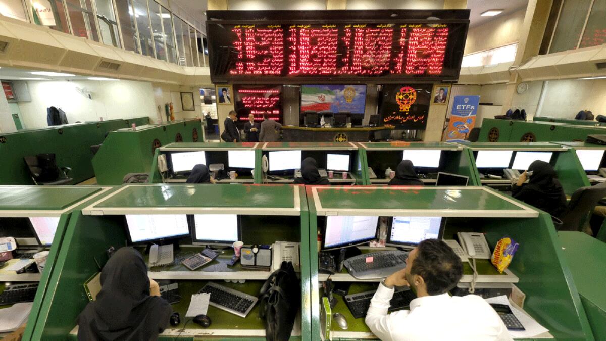 Stock market employees work at Tehran's Stock Exchange.