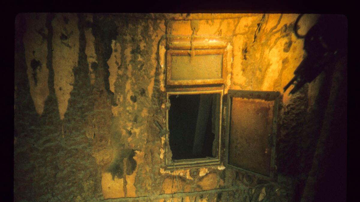 This handout image taken during the historical 1986 dive, courtesy of Woods Hole Oceanographic Institution and released February 15, 2023, shows a porthole on the side of the Titanic. (Photo by Woods Hole Oceanographic Institution/AFP)