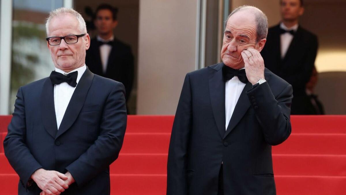Cannes Film Festival President Pierre Lescure (R) and General Delegate Thierry Fremaux wait to greet the cast of the film 'The BFG.   