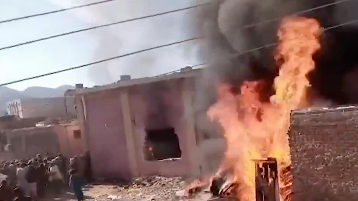 Screengrab from a video shows a mob sets a Hindu temple ablaze in Pakistan's Karak.