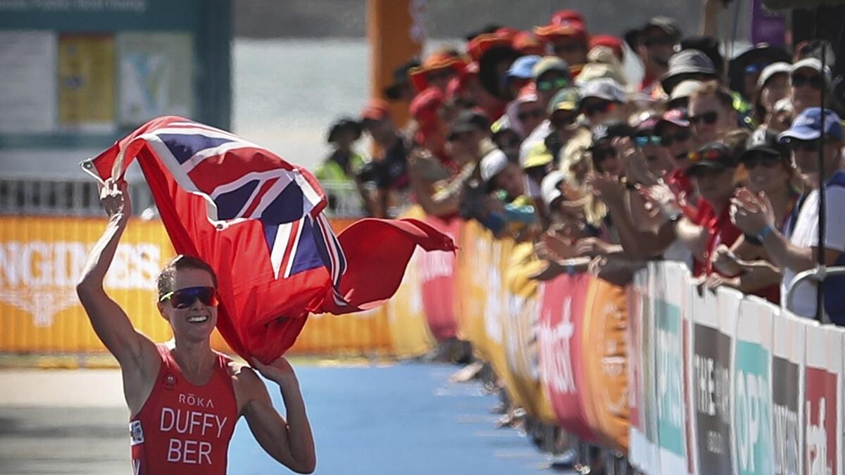 Flora Duffy of Bermuda celebrates as she wins the women's triathlon at Southport Broadwater Parklands.