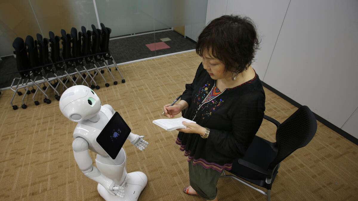 Robot Pepper performs during an interview at the SoftBank Corp.’s headquarters in Tokyo. — AP