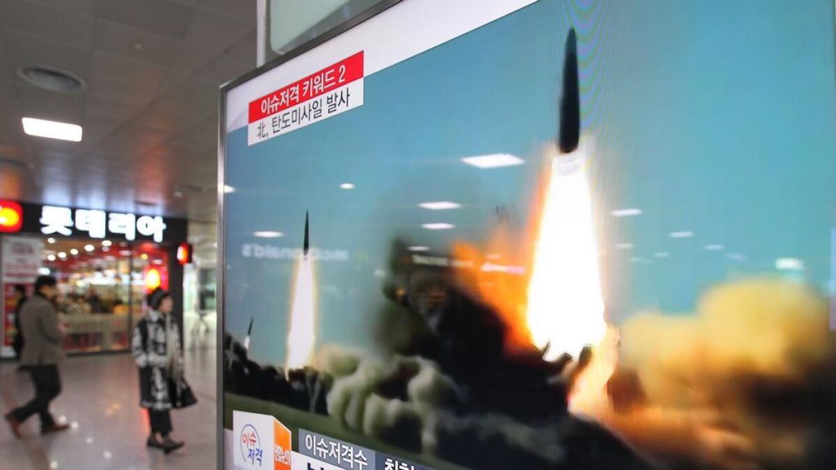 N. Korea fires missiles, plans to liquidate S. Korean assets