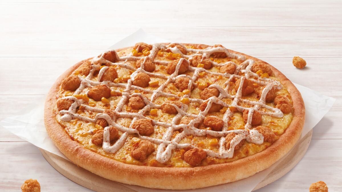 New pizza. By: Pizza hut and KFC. We love a crossover episode on TV, when Peter Griffin shows up in Springfield for example, and now we can enjoy the same experience at local restaurants. KFC and Pizza Hut have teamed up to deliver the new finger lickin’ KFC Chicken Pizza. Pizza Hut’s famous pan dough base is layered with peppery gravy, cheesy goodness and juicy sweetcorn, topped off with KFC chicken pieces and Twister mayo with a Spicy Sprinkle finishing. Delish. On: Right now