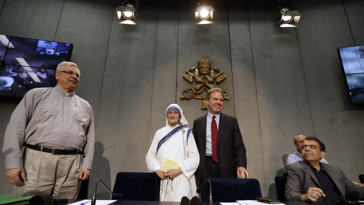From left, Rev. Brian Kolodiejchuk, postulator of the cause of beatification and canonization of Mother Teresa, Sr. Mary Prema Pierick, Superior General of the Missionaries of Charity, Vatican spokesperson Greg Burke, and Marcilio Andrino, arrive for a press conference at the Vatican, Friday, Sept. 2, 2016. Andrino's cure of a viral brain infection, declared a miracle by Pope Francis earlier this year, was the final step needed to declare Mother Teresa a saint. (AP Photo/Alessandra Tarantino)
