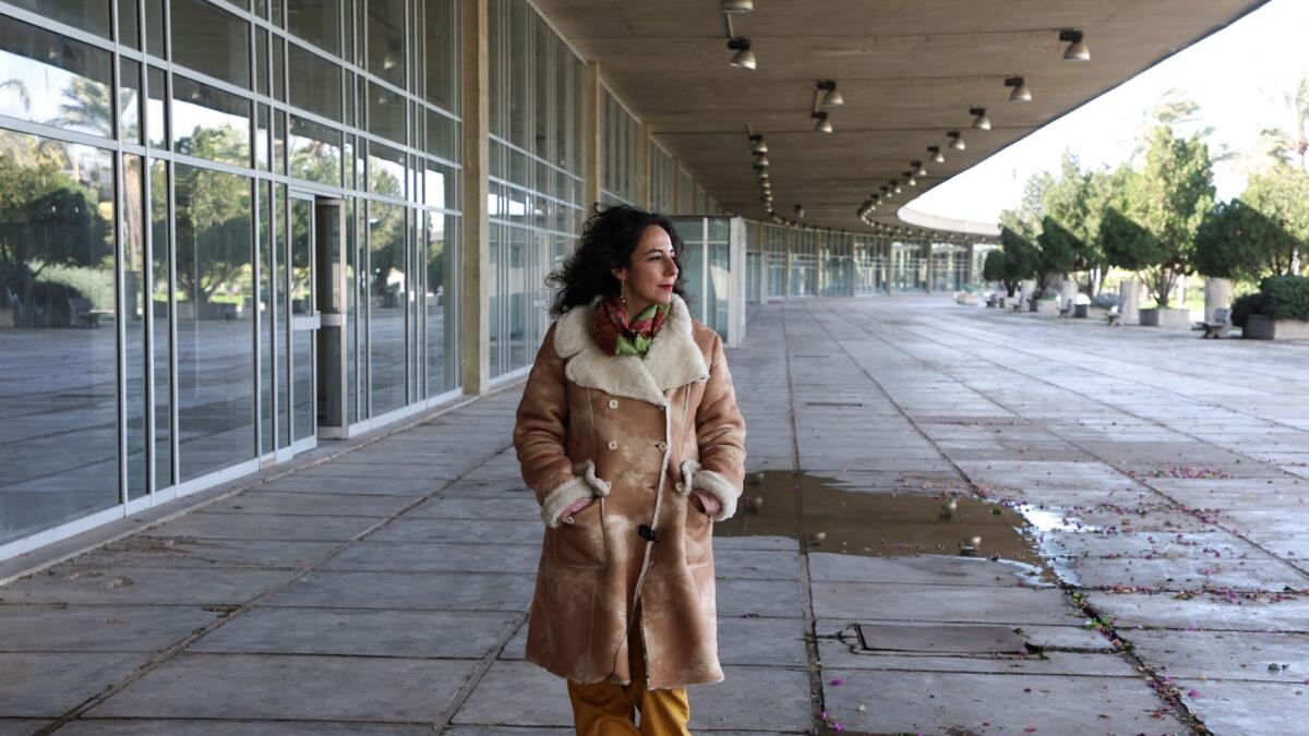 Mira Minkara, a tour guide and a member of the Oscar Niemeyer Foundation Tripoli chapter, walks inside the Rachid Karami International Fair. — Reuters