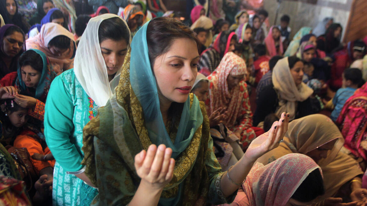 Christian women pray during an Easter service at St Anthony's Church in Lahore, Pakistan. - AP file