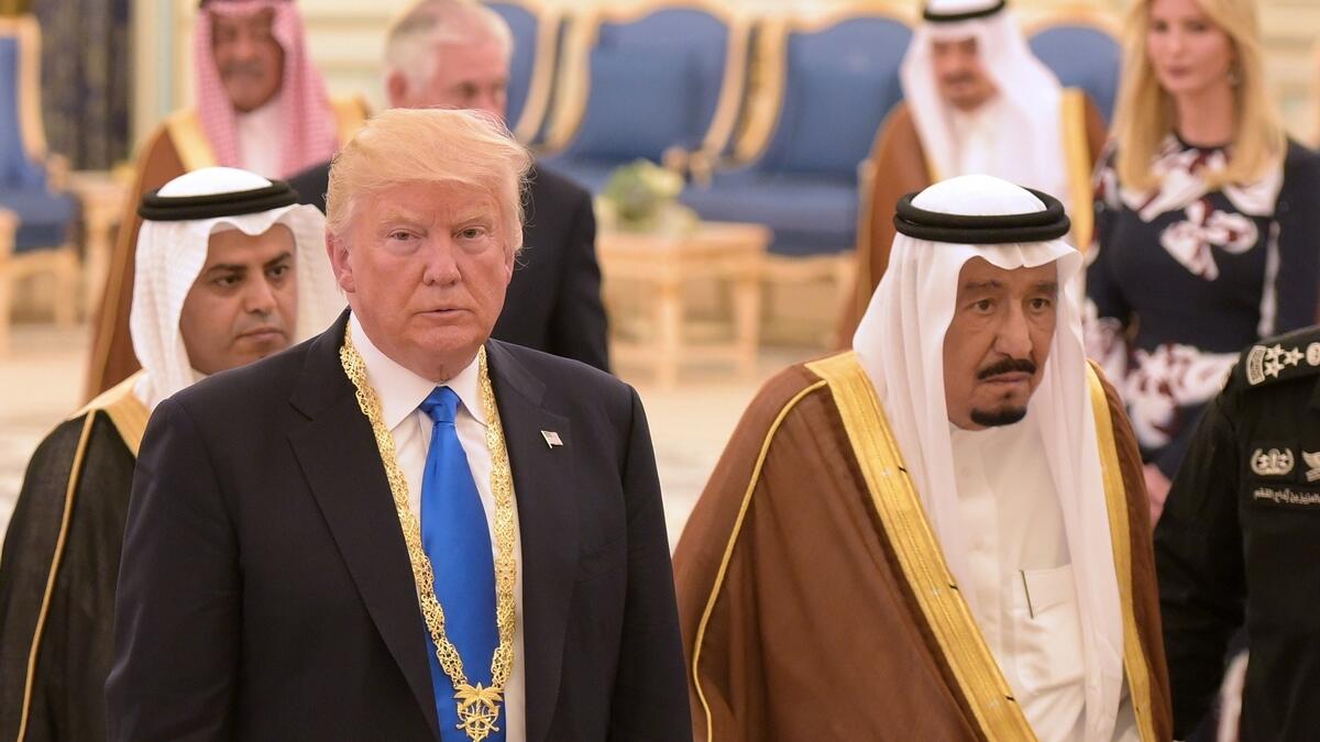 US President Donald Trump (L) walks with Saudi Arabia's King Salman bin Abdulaziz al-Saud after receiving the Order of Abdulaziz al-Saud medal from at the Saudi Royal Court in Riyadh on May 20, 2017.
